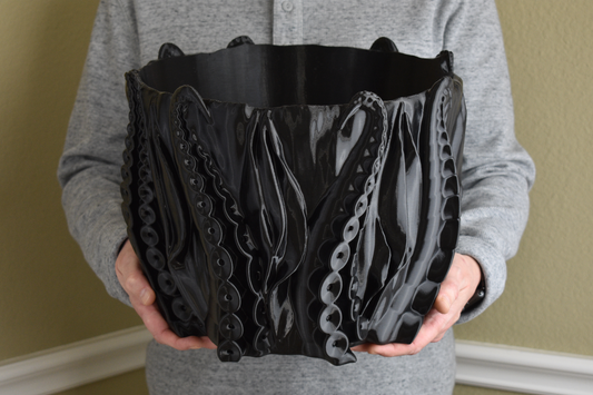 This large striking piece blurs the line between functionality and art. Designed exclusively by GLU3DPrints, the manufacturing/3D printing process for this item takes 80 hours in our shop in Plano, TX.  As a container for your prized indoor plant or by the poolside as themed decor this eclectic planter will serve as a perfect showcase. 
